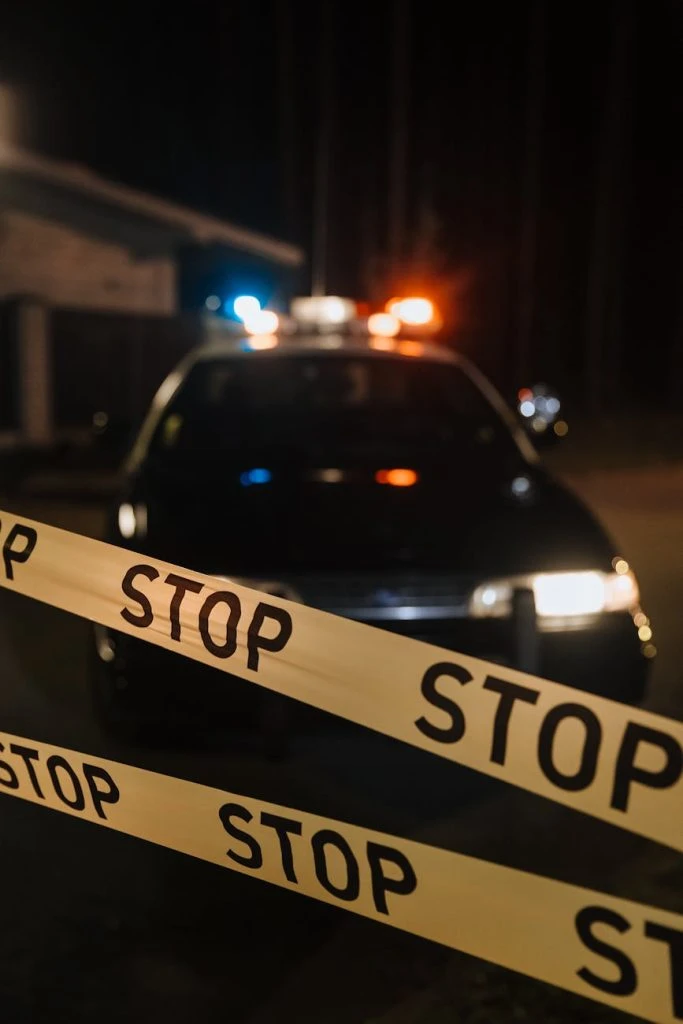 yellow crime tape against police car