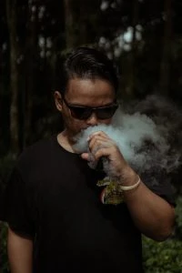 photo of man smoking a vape